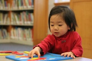 toddler with puzzle