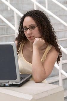 Young Latina Student with Computer and Glasses