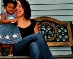 little girl and mom on bench