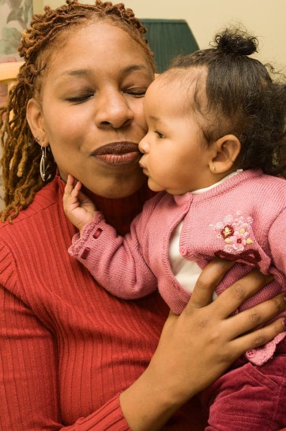 A baby touches her mom's face