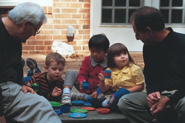 adults and children sit together