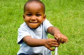 toddler in grassy yard