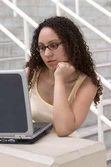 Young Latina Student with Computer and Glasses