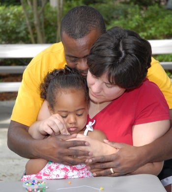 Family sitting on park bench